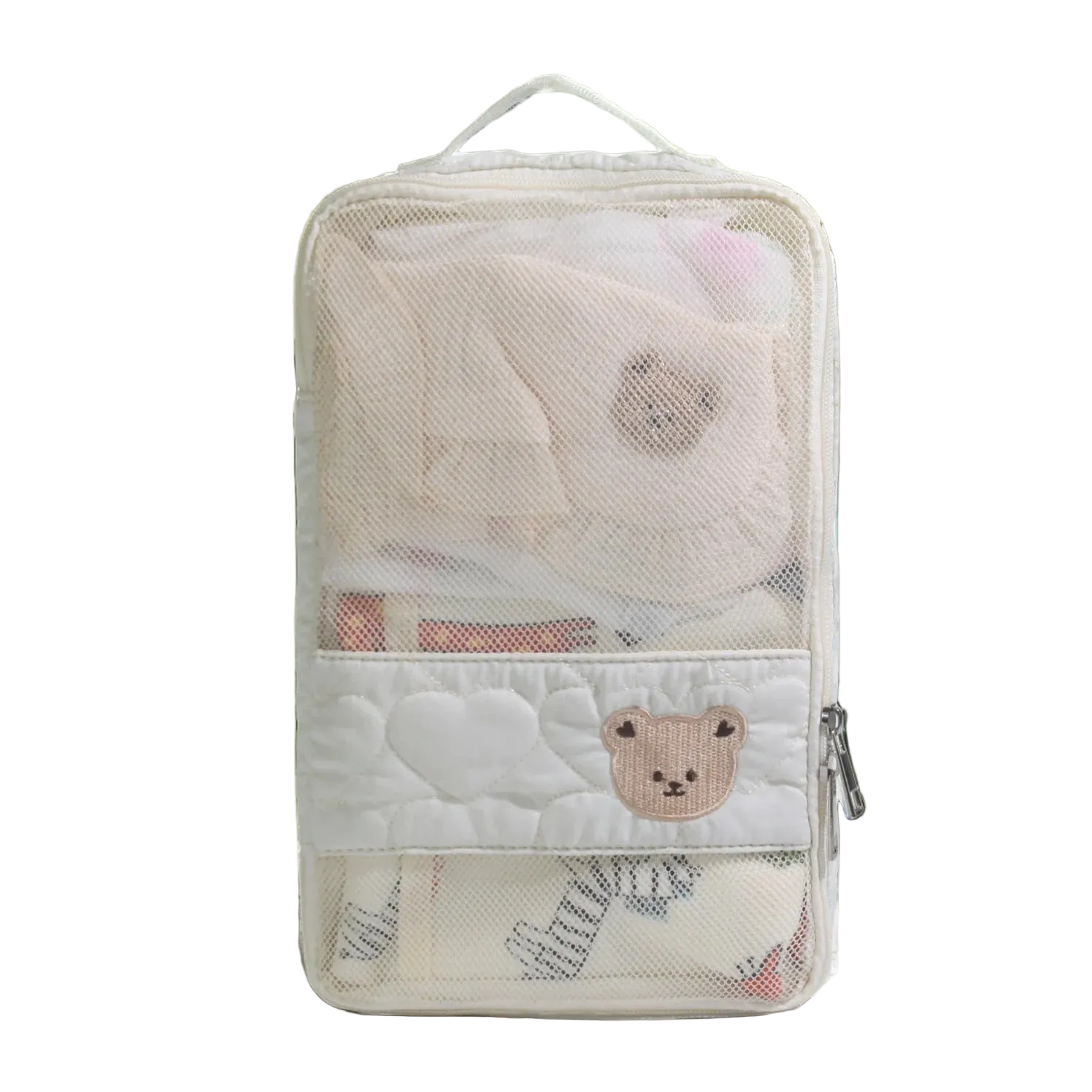 Transparent travel pouch with cartoon bear design on a light surface with greenery.
